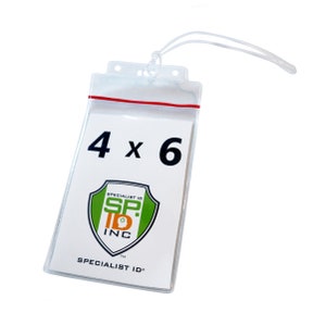 May include: Clear plastic badge holder with a red seam and a white card inside. The card has the text "4 x 6" and a logo for "Specialist ID Inc."