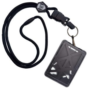 May include: Black lanyard with a detachable buckle and a clear ID holder. The lanyard has a black cord with a black plastic clasp and a metal keyring. The ID holder is a clear plastic with a geometric design.