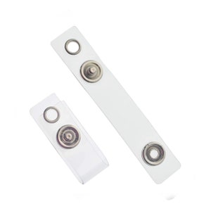 May include: Two clear plastic badge holders with metal snap closures. The holders are designed to be used with lanyards or retractable badge reels.