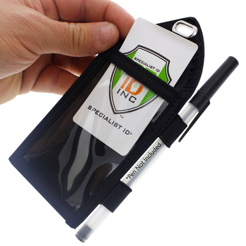May include: Black ID badge holder with a clear plastic window for displaying an ID card. The holder has a strap for attaching a pen, and a loop for attaching a lanyard. The text "SPECIALIST ID" is printed on the ID card.