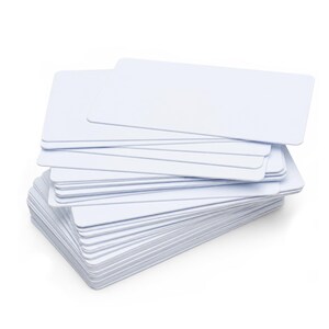 May include: A stack of blank, white rectangular cards with rounded corners. The cards are neatly arranged, showing a clean, minimalist aesthetic. The cards are stacked on top of each other.