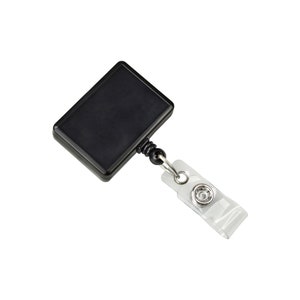 May include: Black retractable badge holder with a clear plastic strap and a metal clip. The badge holder has a rectangular shape and a smooth surface.