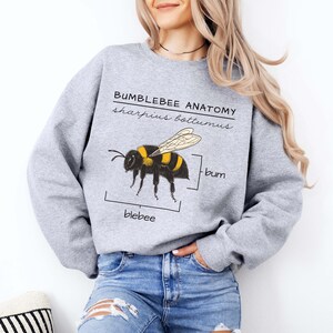 Pu&ograve; includere: Una felpa grigia con una grafica di un bombo e il testo "Bumblebee Anatomy, sharpus bottomus, bum, blebee".