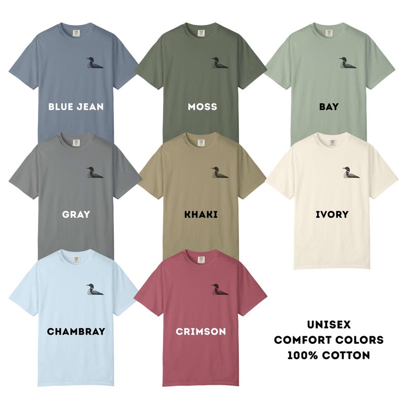 May include: A collection of unisex Comfort Colors t-shirts in various shades, including blue jean, moss, gray, khaki, ivory, chambray, and crimson. Each shirt features a small embroidered design and is made of 100% cotton.