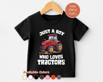 May include: Black t-shirt with a red tractor graphic. The text reads "JUST A BOY WHO LOVES TRACTORS". Available in sizes 3/6M to Youth L. Several color options are shown at the bottom of the image.