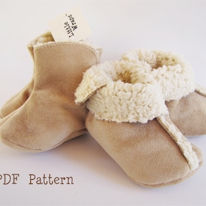 May include: A pair of tan suede baby booties with a white faux fur lining. The booties are labeled "Little Wraps". PDF Pattern.