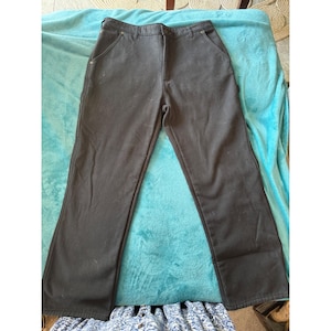 May include: Black pants with a classic five-pocket design. The pants have a straight leg cut and a button and zipper closure. The pants are made of a durable material and are suitable for everyday wear.