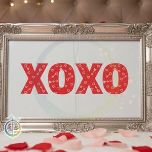 May include: A framed print with the letters "XOXO" in red, filled with heart and arrow patterns. The frame is ornate silver, and the background includes red and pink rose petals, suggesting a Valentine's Day theme.