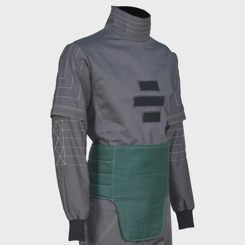 May include: A charcoal gray long-sleeve shirt featuring a high collar, white geometric line stitching on the sleeves, and three black rectangular patches on the chest. A dark green padded waist guard with horizontal stitching is worn over the shirt.