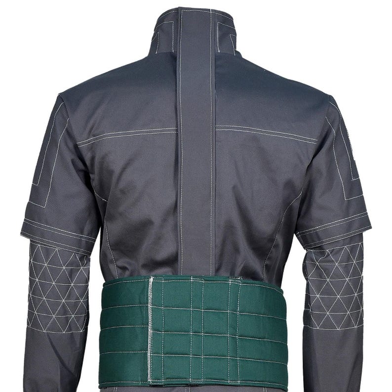 May include: A dark gray jacket featuring a high collar, a vertical center seam, and white topstitching. The sleeves have a geometric triangular pattern on the forearms. A wide, quilted dark green belt is attached around the waist area.