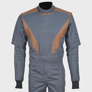 May include: A grey jumpsuit featuring brown leather-like panels on the chest and shoulders. The garment includes a high collar, short sleeves layered over long sleeves with white contrast stitching, and black ribbed cuffs at the wrists.