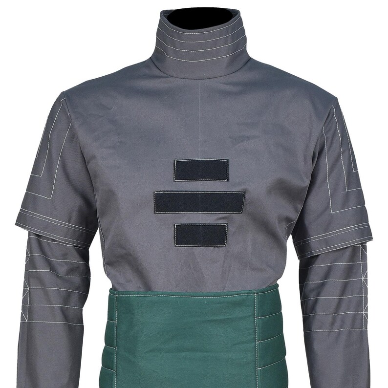 May include: A grey mock neck shirt featuring white geometric line stitching on the shoulders and sleeves, three horizontal black rectangular patches on the chest, and a wide, dark green horizontal panel around the waist with quilted stitching.
