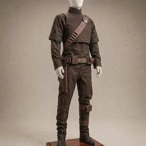 May include: A dark brown tactical costume set displayed on a mannequin, featuring a high-neck long-sleeve shirt, matching trousers, a diagonal shoulder strap with utility slots, a waist belt with pouches and a holster, and dark brown boots.