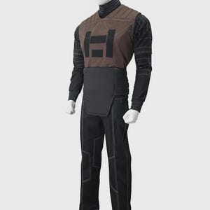 May include: A costume set on a mannequin featuring a brown quilted vest with a black geometric emblem, worn over a black long-sleeve shirt with white line patterns. The outfit includes a black waist guard and matching black trousers with white stitching.