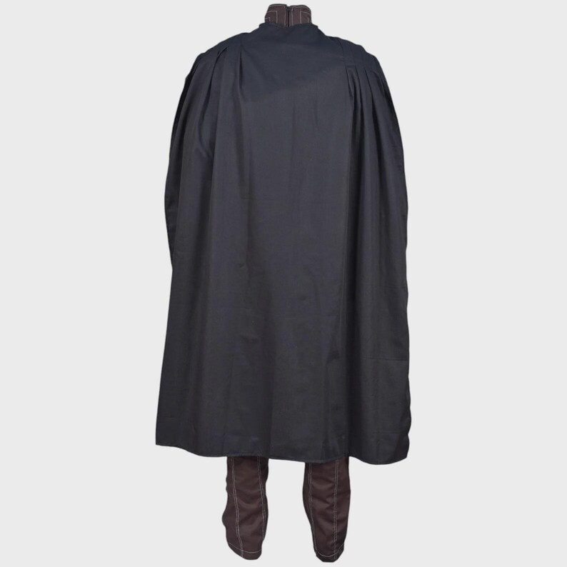 May include: A long, solid black cape with a high collar featuring a subtle brown pinstripe pattern. The cape is draped over a pair of matching brown trousers that also display a thin, vertical pinstripe design and visible white stitching.