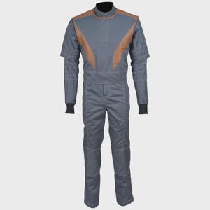May include: A gray jumpsuit featuring a high collar, short sleeves, and brown panels on the chest and shoulders. The garment includes white topstitching details, a fitted waist, and black ribbed cuffs at the ends of the sleeves, creating a structured look.