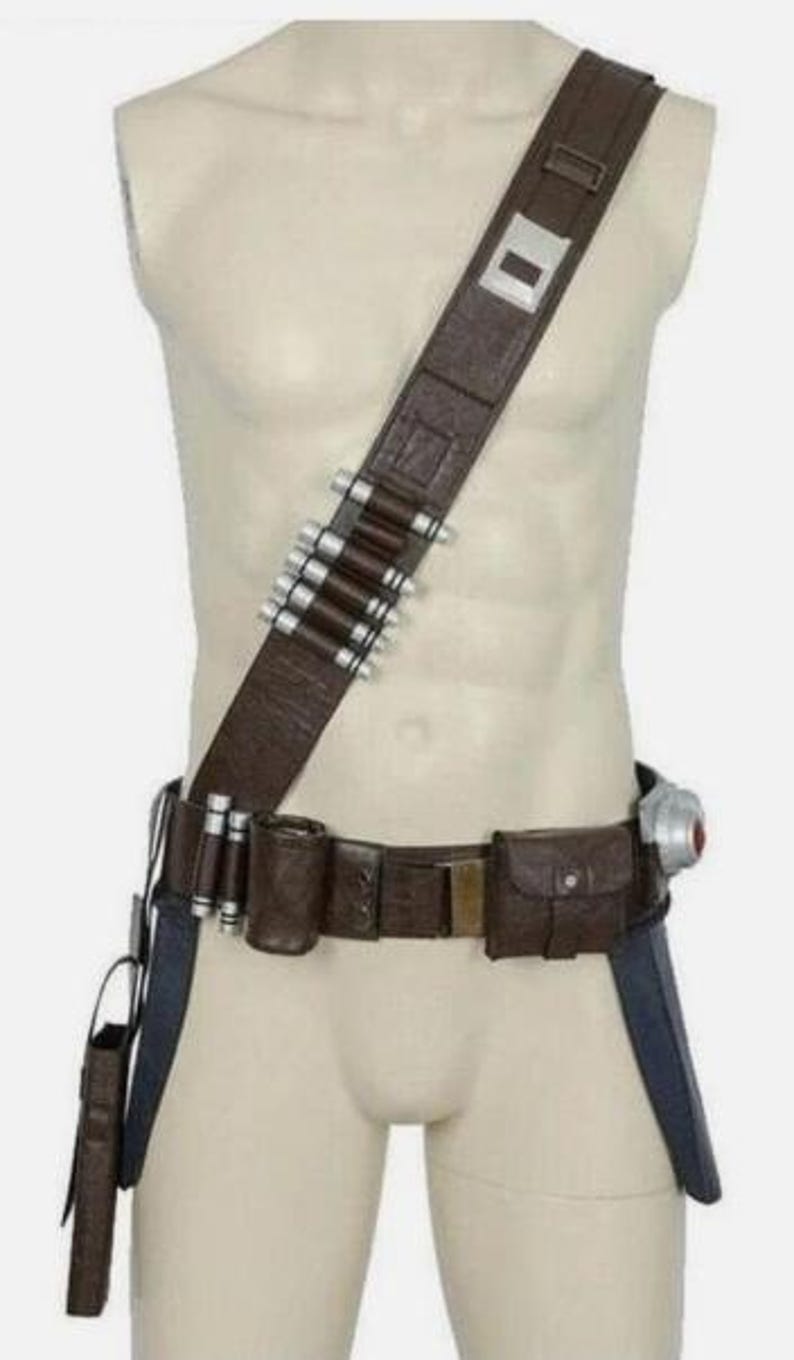 May include: A brown leather-like utility belt and shoulder strap set featuring a series of silver-toned cylindrical canisters attached to the diagonal strap and waist belt, along with a small rectangular pouch and a holster-style attachment.