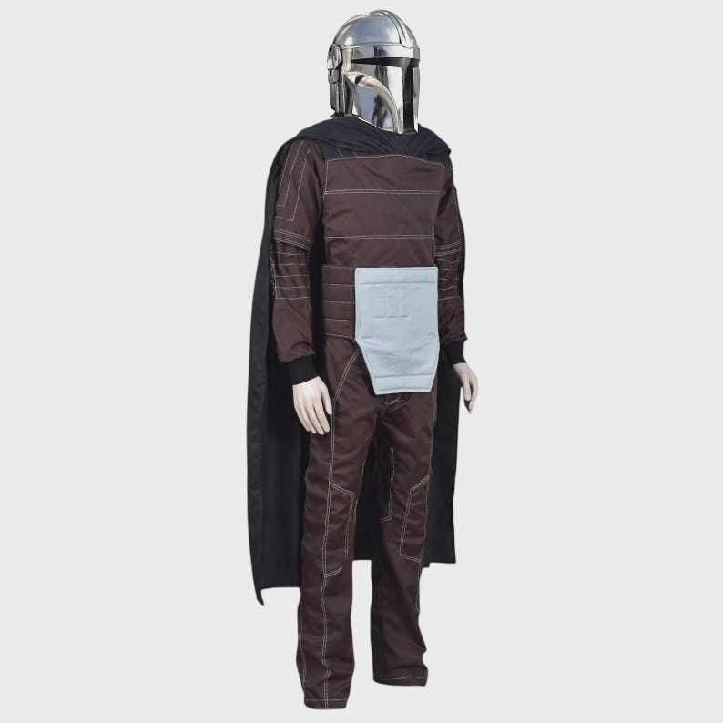 May include: A full-body costume featuring a metallic silver helmet with a T-shaped visor, a dark brown long-sleeved jumpsuit with white contrast stitching, a light gray rectangular waist panel, and a long black cape draped over the shoulders.