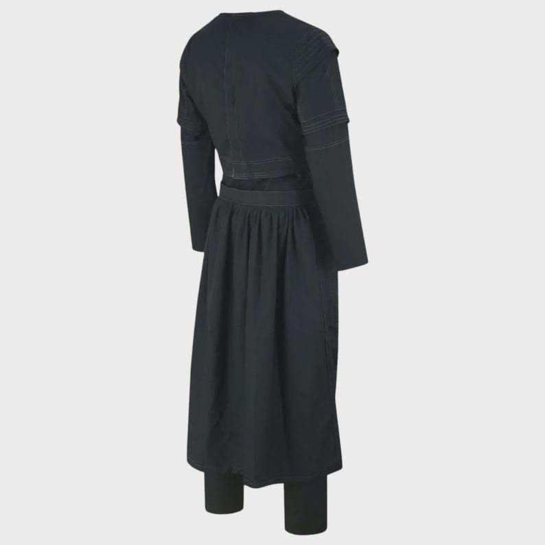 May include: A black long-sleeved dress featuring a structured bodice with visible white stitching details, a high neckline, and a pleated skirt that falls below the knees. The garment has a fitted waistline and long sleeves with stitched accents.
