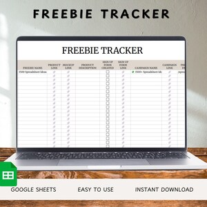 May include: A laptop screen shows a "FREEBIE TRACKER" spreadsheet, with columns for product details and sign-up links. The laptop is on a wooden surface. The text at the bottom reads "GOOGLE SHEETS," "EASY TO USE," and "INSTANT DOWNLOAD."