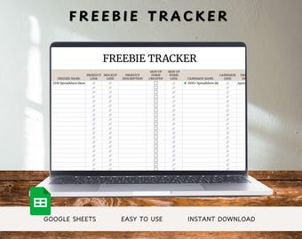 May include: A laptop displays a spreadsheet titled "FREEBIE TRACKER." The screen shows a table with columns for product links, descriptions, and sign-up forms. The laptop sits on a wooden surface. Text at the bottom reads "GOOGLE SHEETS," "EASY TO USE," and "INSTANT DOWNLOAD."