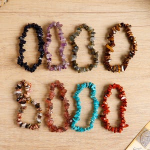 May include: A set of three ceramic mugs with a speckled, matte finish. The mugs are in shades of cream, light gray, and dark gray. Each mug has a simple, minimalist design and a rounded handle.