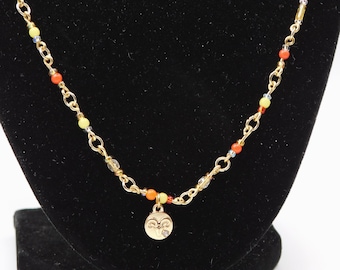 Colar de contas douradas do signo de Áries