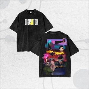 May include: Two black t-shirts with a distressed wash. One shirt features the word "DISPATCH" in white block letters with a yellow accent. The other shirt has a graphic design on the back with multiple illustrated characters.