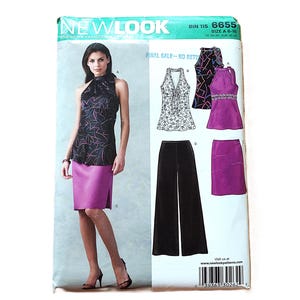 May include: A New Look sewing pattern showing a woman in a black and pink halter top and a purple skirt. The pattern also displays other garment options, including a floral top, black trousers, and a purple skirt.