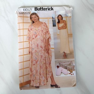 May include: A Butterick sewing pattern envelope, featuring a woman in a flowing, patterned dress. The pattern number is 6045. The envelope also shows a woman in a strapless dress and images of accessories.
