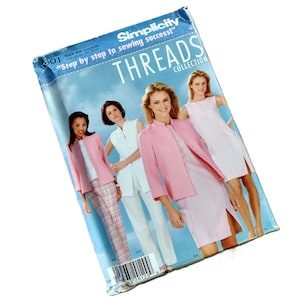 May include: A white ceramic mug with a black handle and the text "But First, Coffee" in a bold, black font. The mug is set against a neutral background, highlighting its simple design.