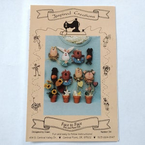 May include: A tan instructional booklet titled Inspired Creations Face to Face Pins and Plant Pals. The cover features a black sewing machine graphic and a central photograph displaying various small fabric animal pins and potted plant decorations.