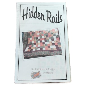 May include: A white instructional booklet titled Hidden Rails featuring a central photograph of a multi-coloured patchwork quilt with pink, white, and dark floral squares. The bottom includes the text The Patchwork Puppy Patterns with a small illustration.