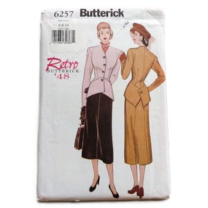 May include: A Butterick 6257 sewing pattern envelope featuring the text Retro Butterick '48. The illustration displays two outfits: a light pink jacket with a black skirt and a tan pinstriped jacket with a matching tan pinstriped skirt.