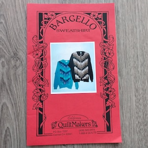 May include: A red brochure with the text "BARGELLO SWEATSHIRT" and "California QuiltMakers." It features a photo of two zip-up sweatshirts with chevron patterns in blue and black. The brochure has black floral border designs.