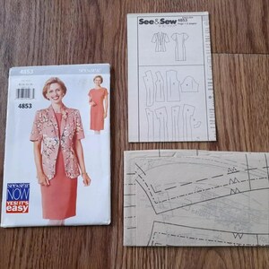 May include: A vintage sewing pattern packet, featuring a woman in a coral suit with a floral jacket. The packet includes pattern pieces and instructions. The brand is See & Sew.