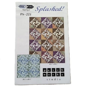 May include: A paper pattern for an appliqué quilt, titled "Splashed!" with the text "Give & Take" and "PS-223". The design features a repeating geometric pattern in shades of brown, purple, and cream. The larger quilt measures 108 cm x 144 cm, and a smaller version is 72 cm x 72 cm.