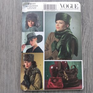May include: A Vogue Accessories sewing pattern envelope V8141 featuring illustrations of various winter accessories including a green faux fur hat and scarf, a leopard print hat and vest, a wide-brimmed hat, and two handbags in red and brown.