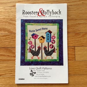 May include: A paper pattern booklet titled Roosters & Hollyhock Paper-Pieced & Applique Wallhanging. The cover features a quilt design with two black and white spotted roosters, three birdhouses, and pink flowers with the text Home Sweet Home.