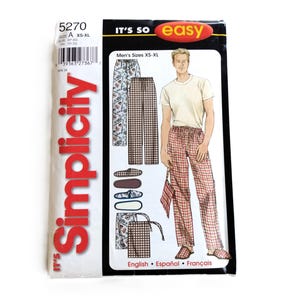 May include: A Simplicity sewing pattern envelope, number 5270, for lounge trousers and slippers. The packaging features the text 'IT'S SO easy' and 'Simplicity'. Illustrations show plaid and patterned trousers, a matching drawstring bag, and slippers.