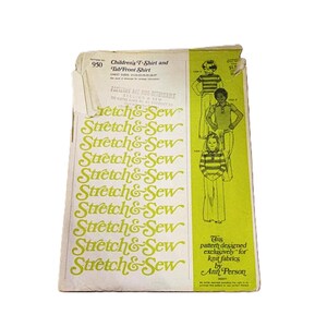 May include: A vintage Stretch & Sew pattern envelope number 950 for a children's T-shirt and tab-front shirt. The white and lime green paper packaging features illustrations of children wearing the garments and text including the brand name.