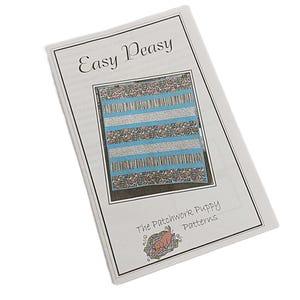 May include: A white paper pattern booklet titled Easy Peasy with a central illustration of a quilt featuring alternating horizontal stripes of blue, white, and a multi-colored puppy print. The text The Patchwork Puppy Patterns appears below.