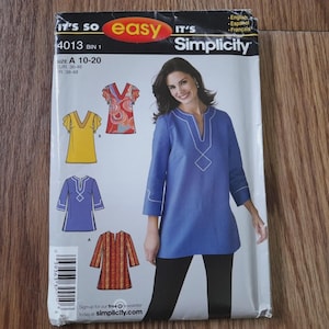 May include: Simplicity sewing pattern 4013, featuring a woman in a blue tunic. The pattern includes various tunic designs in yellow, red, and blue. The package has the text "IT'S SO easy" and "Simplicity". Size A 10-20.