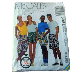 May include: McCall's sewing pattern envelope showing four people wearing patterned shorts. The shorts designs include food packaging, green polka dots, lemons, and baseball bats. The envelope has the text "McCall's" and "The Easy 60 min Pattern".