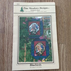 May include: A set of three ceramic mugs with a speckled, matte finish. The mugs are in shades of cream, light gray, and dark gray. Each mug has a simple, minimalist design and a rounded handle. The mugs are stacked on top of each other.