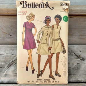May include: A Butterick 5865 sewing pattern envelope for size 20 1/2 and bust 43. The illustration features three outfits: a purple short-sleeved dress, a beige jacket with a matching skirt, and a sleeveless beige dress with a belt.