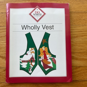May include: A pattern booklet titled Wholly Vest with a red border and a white cover. The graphic features a green vest outline decorated with a winter scene on the left side and an angel illustration on the right side, with Do North branding.