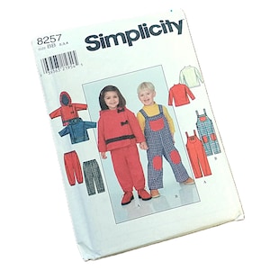 May include: Simplicity pattern 8257 for children's clothing. The cover shows illustrations of a red hooded jacket, blue jacket, red trousers, and dungarees. The Simplicity logo and pattern number 8257 are visible on the cover.