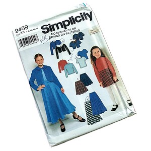 May include: A Simplicity 9459 sewing pattern envelope for children's clothing. The front displays illustrations of a blue jacket, a long blue skirt, a red long-sleeve top, and plaid skirts. Text includes Simplicity, 9459, and size K5 7, 8, 10, 12, 14.