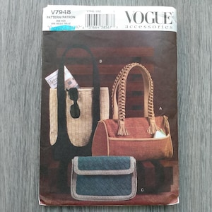 May include: Vogue accessories pattern featuring three bag designs: a woven tote, a cylindrical bag with braided handles, and a small clutch. The bags are in neutral tones with a touch of teal. The pattern number is V7948.